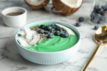 Bowl of spirulina smoothie served on marble table