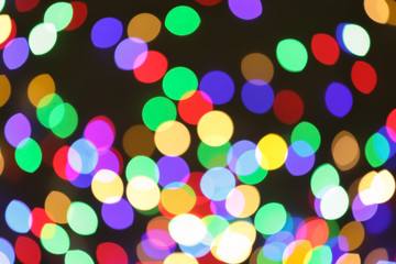 Beautiful colorful lights on dark background. Bokeh effect