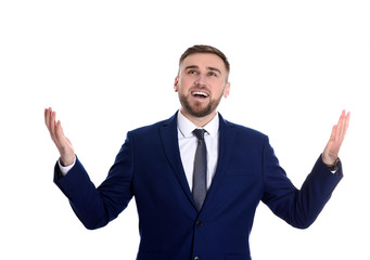 Young businessman under rain of money on white background