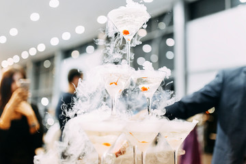 pyramid of martini glasses with dry ice