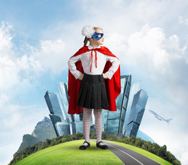 Girl power concept with cute kid guardian against cityscape background