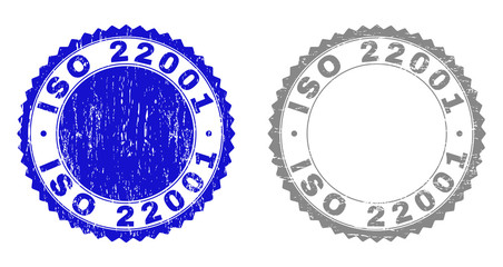 Grunge ISO 22001 stamp seals isolated on a white background. Rosette seals with grunge texture in blue and gray colors. Vector rubber stamp imitation of ISO 22001 title inside round rosette.