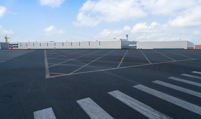 Road asphalt pavement and modern factory warehouse..