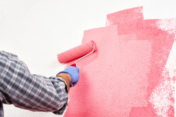 Professional house painter at work painting the wall © francescomou
