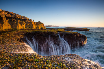 Wide angle landscape image of the dramatic sandstone rock formations along the coastline of...