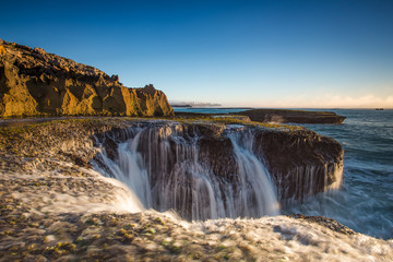 Wide angle landscape image of the dramatic sandstone rock formations along the coastline of Arniston in th Western Cape of South Africa.