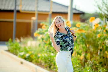 beautiful blonde in the garden of a sunny summer day
