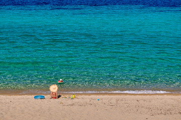 Toddler boy on beach with mother