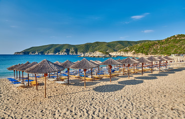 Beach with loungers and umbrellas in Greece