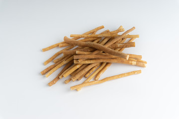 Natural toothbrush Miswak (Kayu Sugi) on white background with selective focus. It is a teeth cleaning twig made from the Salvadora persica tree and also know as miswaak, siwak, Sugi or sewak