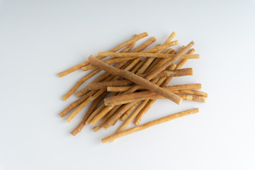 Natural toothbrush Miswak (Kayu Sugi) on white background with selective focus. It is a teeth cleaning twig made from the Salvadora persica tree and also know as miswaak, siwak, Sugi or sewak