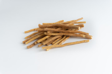 Natural toothbrush Miswak (Kayu Sugi) on white background with selective focus. It is a teeth cleaning twig made from the Salvadora persica tree and also know as miswaak, siwak, Sugi or sewak