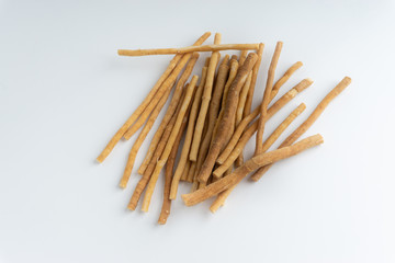 Natural toothbrush Miswak (Kayu Sugi) on white background with selective focus. It is a teeth cleaning twig made from the Salvadora persica tree and also know as miswaak, siwak, Sugi or sewak