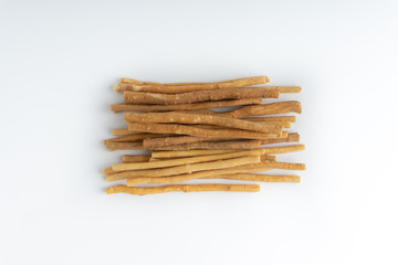 Natural toothbrush Miswak (Kayu Sugi) on white background with selective focus. It is a teeth cleaning twig made from the Salvadora persica tree and also know as miswaak, siwak, Sugi or sewak