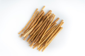 Natural toothbrush Miswak (Kayu Sugi) on white background with selective focus. It is a teeth cleaning twig made from the Salvadora persica tree and also know as miswaak, siwak, Sugi or sewak