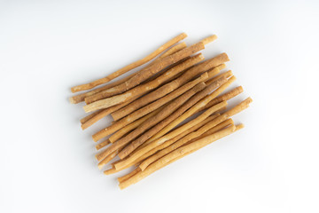 Natural toothbrush Miswak (Kayu Sugi) on white background with selective focus. It is a teeth cleaning twig made from the Salvadora persica tree and also know as miswaak, siwak, Sugi or sewak