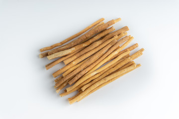 Natural toothbrush Miswak (Kayu Sugi) on white background with selective focus. It is a teeth cleaning twig made from the Salvadora persica tree and also know as miswaak, siwak, Sugi or sewak
