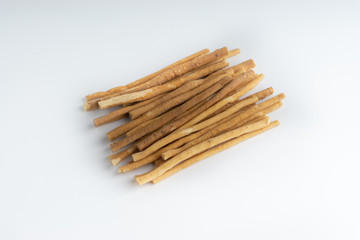 Natural toothbrush Miswak (Kayu Sugi) on white background with selective focus. It is a teeth cleaning twig made from the Salvadora persica tree and also know as miswaak, siwak, Sugi or sewak