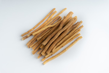 Natural toothbrush Miswak (Kayu Sugi) on white background with selective focus. It is a teeth cleaning twig made from the Salvadora persica tree and also know as miswaak, siwak, Sugi or sewak