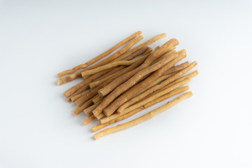 Natural toothbrush Miswak (Kayu Sugi) on white background with selective focus. It is a teeth cleaning twig made from the Salvadora persica tree and also know as miswaak, siwak, Sugi or sewak
