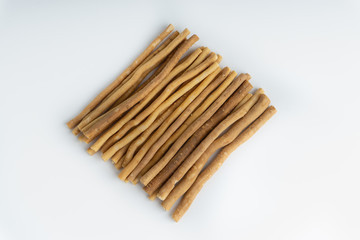 Natural toothbrush Miswak (Kayu Sugi) on white background with selective focus. It is a teeth cleaning twig made from the Salvadora persica tree and also know as miswaak, siwak, Sugi or sewak
