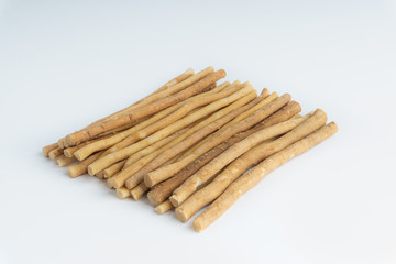 Natural toothbrush Miswak (Kayu Sugi) on white background with selective focus. It is a teeth cleaning twig made from the Salvadora persica tree and also know as miswaak, siwak, Sugi or sewak