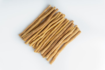 Natural toothbrush Miswak (Kayu Sugi) on white background with selective focus. It is a teeth cleaning twig made from the Salvadora persica tree and also know as miswaak, siwak, Sugi or sewak
