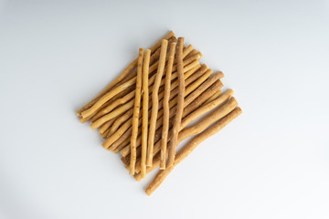Natural toothbrush Miswak (Kayu Sugi) on white background with selective focus. It is a teeth cleaning twig made from the Salvadora persica tree and also know as miswaak, siwak, Sugi or sewak