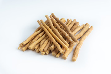 Natural toothbrush Miswak (Kayu Sugi) on white background with selective focus. It is a teeth cleaning twig made from the Salvadora persica tree and also know as miswaak, siwak, Sugi or sewak