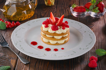 Millefeuille dessert with strawberries on wooden table