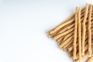 Natural toothbrush Miswak (Kayu Sugi) on white background with selective focus. It is a teeth cleaning twig made from the Salvadora persica tree and also know as miswaak, siwak, Sugi or sewak