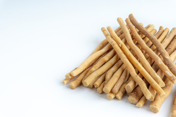 Natural toothbrush Miswak (Kayu Sugi) on white background with selective focus. It is a teeth cleaning twig made from the Salvadora persica tree and also know as miswaak, siwak, Sugi or sewak