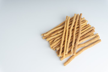 Natural toothbrush Miswak (Kayu Sugi) on white background with selective focus. It is a teeth cleaning twig made from the Salvadora persica tree and also know as miswaak, siwak, Sugi or sewak