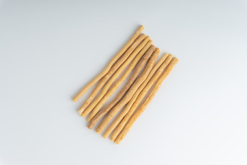 Natural toothbrush Miswak (Kayu Sugi) on white background with selective focus. It is a teeth cleaning twig made from the Salvadora persica tree and also know as miswaak, siwak, Sugi or sewak
