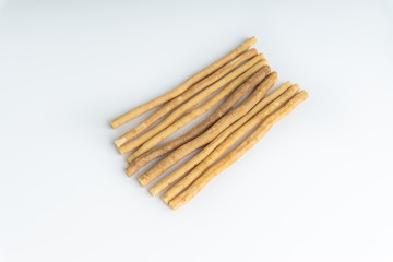 Natural toothbrush Miswak (Kayu Sugi) on white background with selective focus. It is a teeth cleaning twig made from the Salvadora persica tree and also know as miswaak, siwak, Sugi or sewak