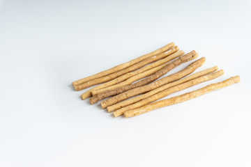 Natural toothbrush Miswak (Kayu Sugi) on white background with selective focus. It is a teeth cleaning twig made from the Salvadora persica tree and also know as miswaak, siwak, Sugi or sewak