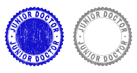 Grunge JUNIOR DOCTOR stamp seals isolated on a white background. Rosette seals with grunge texture in blue and gray colors. Vector rubber stamp imitation of JUNIOR DOCTOR title inside round rosette.
