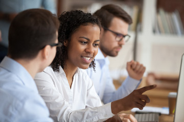 African young intern or mixed-race new employee talking to mentor