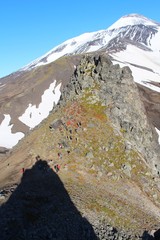 Top of the Verblyud (literally: Camel) extrusion rock at the foot of Avachinsky volcano. Tourists are visible on the slope.