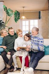 awesome family remembering sweet moments. people are looking at family picture. awesome little girl...