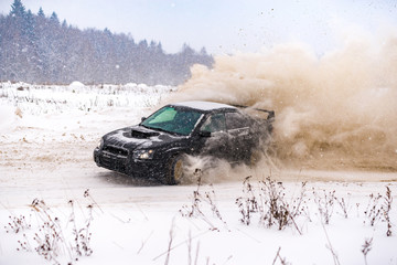 Closeup of car drifting in winter on the road covered with snow