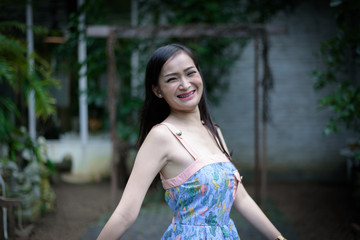 Asian pretty girl has relaxing with happy and smiling at Little Tree Garden cafe, Nakhon Pathom province, Thailand in the morning.