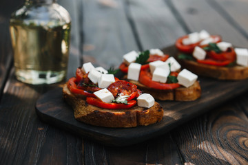 Homemade bruschetta with grilled tomatoes and feta