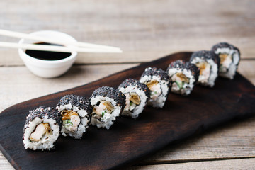 sushi rolls with smoked eel in black sesame