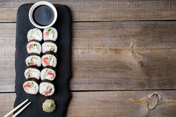 Sushi with sauce and chopsticks served on plate