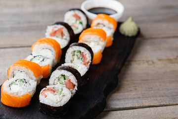 Japanese sushi rolls with salmon, food background