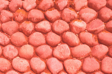 Covering, stone blocks from natural stones. Paving from natural materials. Living Coral creative and moody color