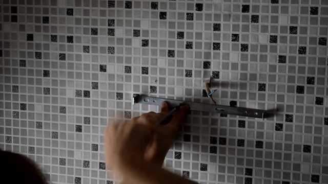 Electrician replacing old wall lamp