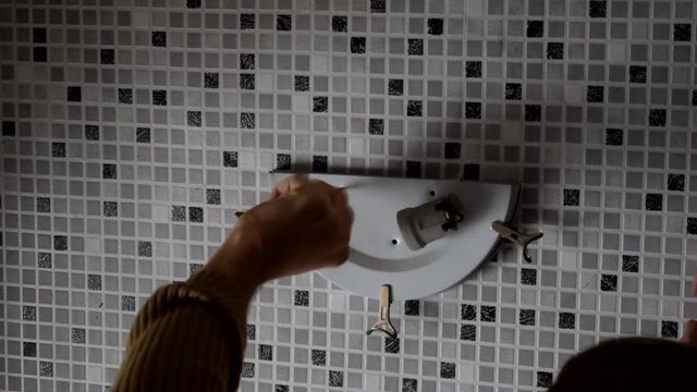 Electrician replacing old wall lamp