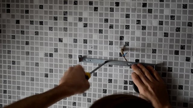 Electrician replacing old wall lamp